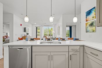 A modern kitchen with a large island and stainless steel appliances.